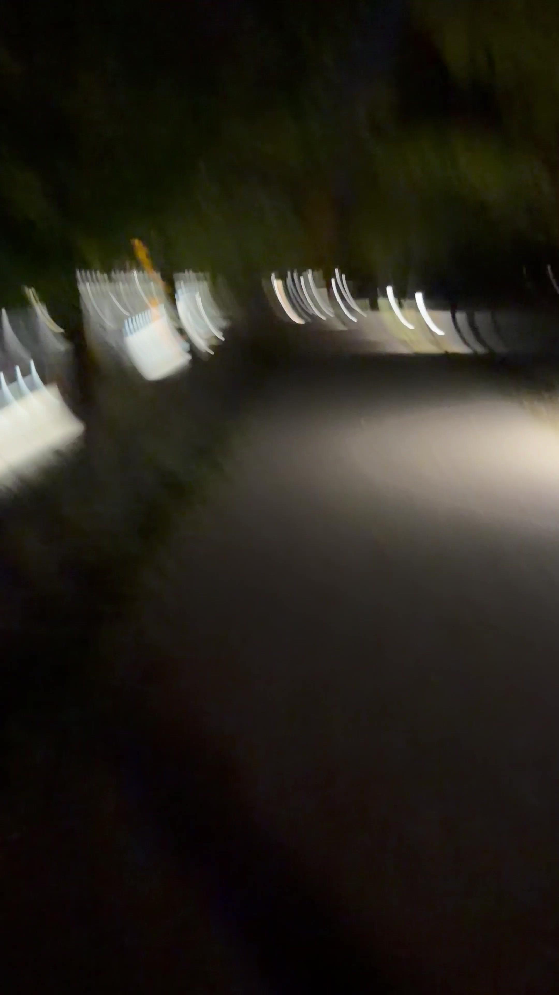 Man Jogging at Night While Holding Camera