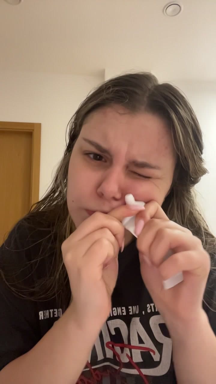 Young Woman Applying Skincare Cream Playfully