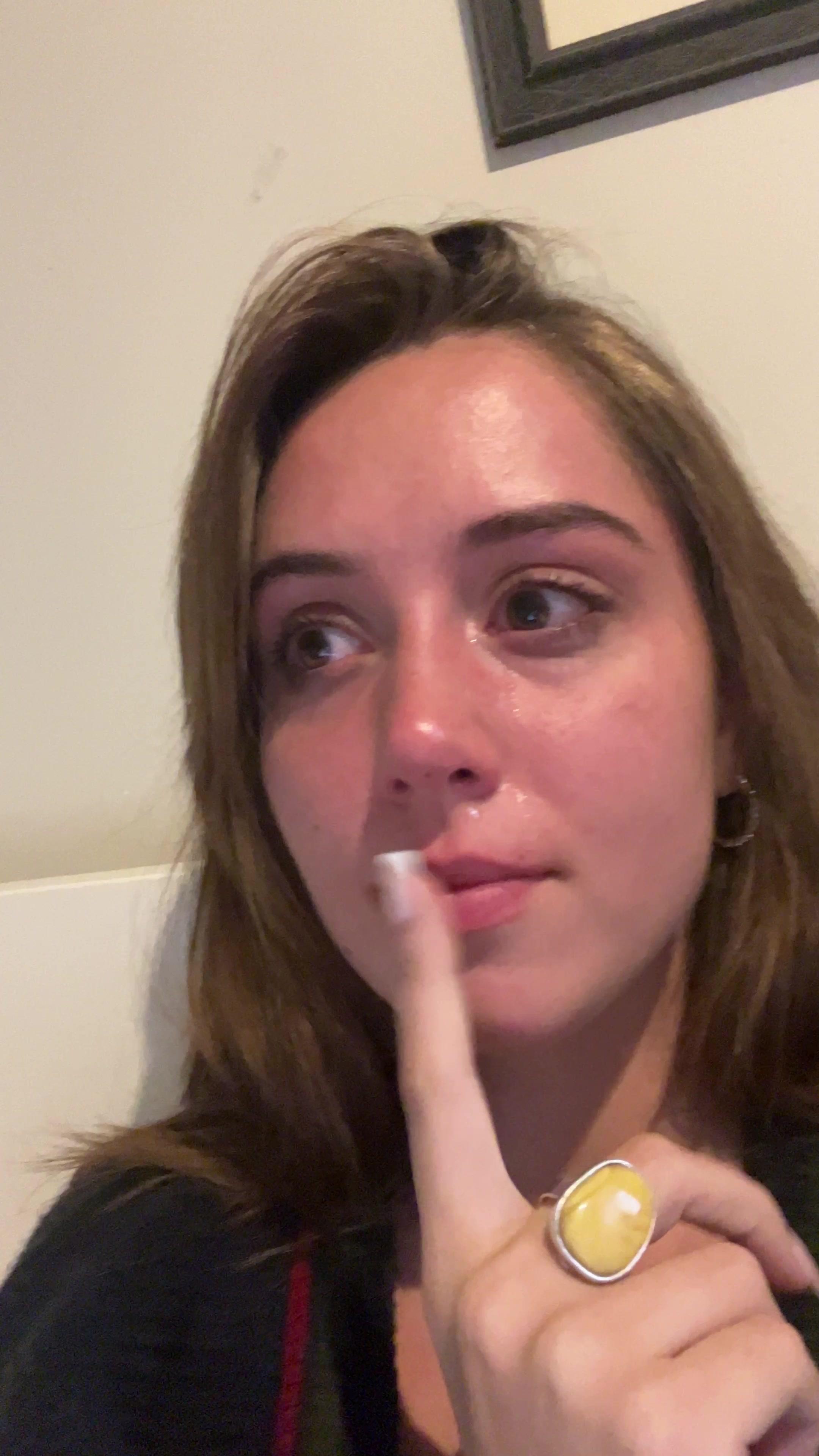 Tearful Young Woman Making Shushing Gesture